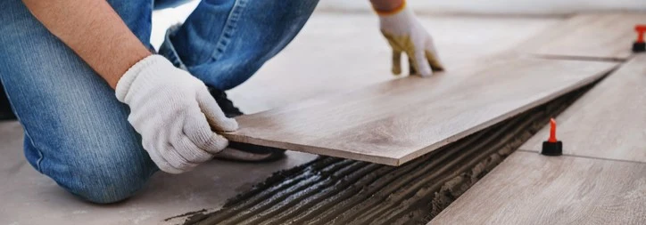 A carpenter adding flooring in