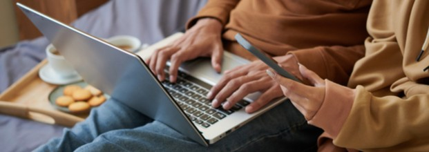 A couple doing their finances on a laptop