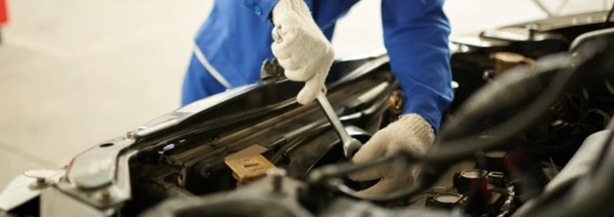 A mechanic working on a car