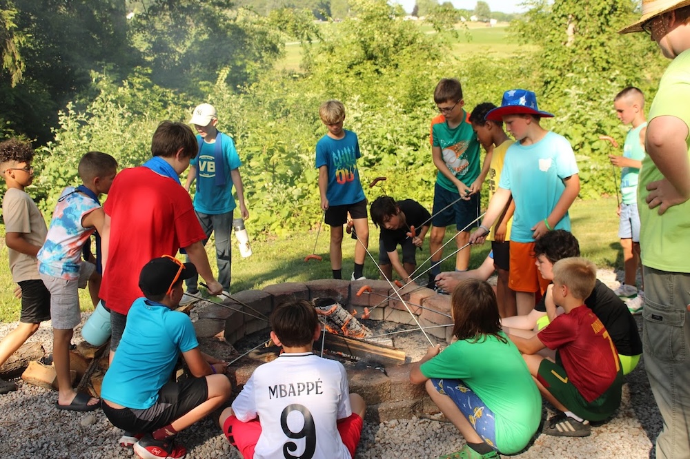 Campers around a fire at Camp Whitley