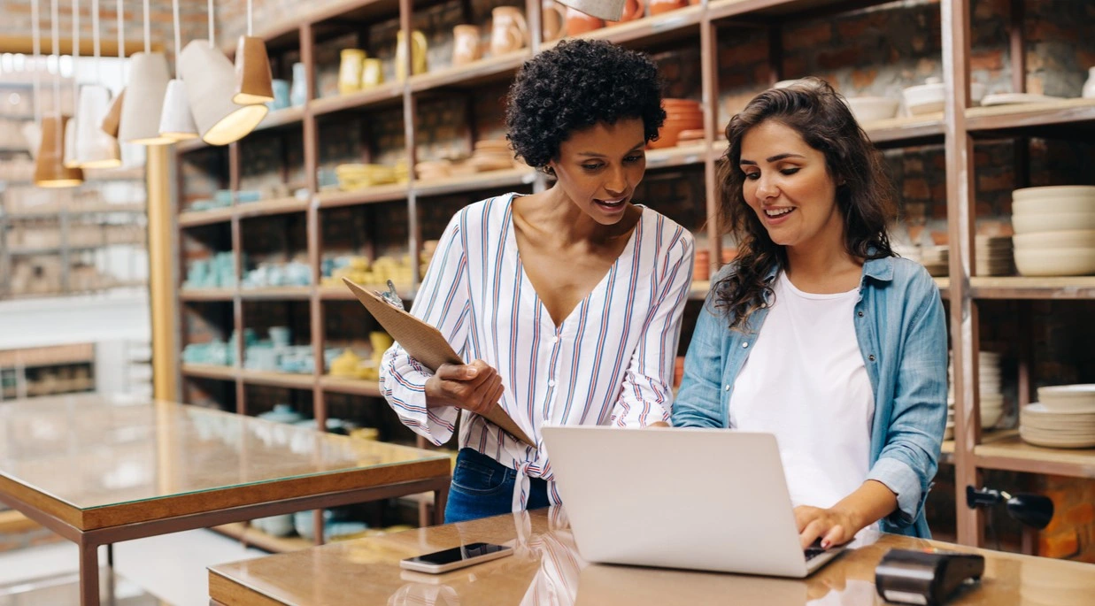 Two store owners looking at their laptop
