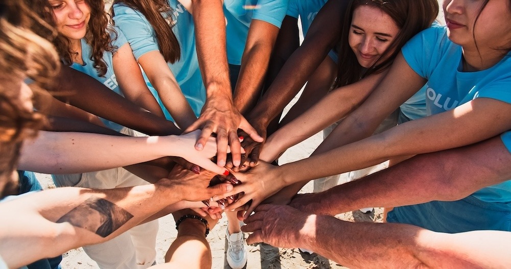 A community of people putting their hands in together