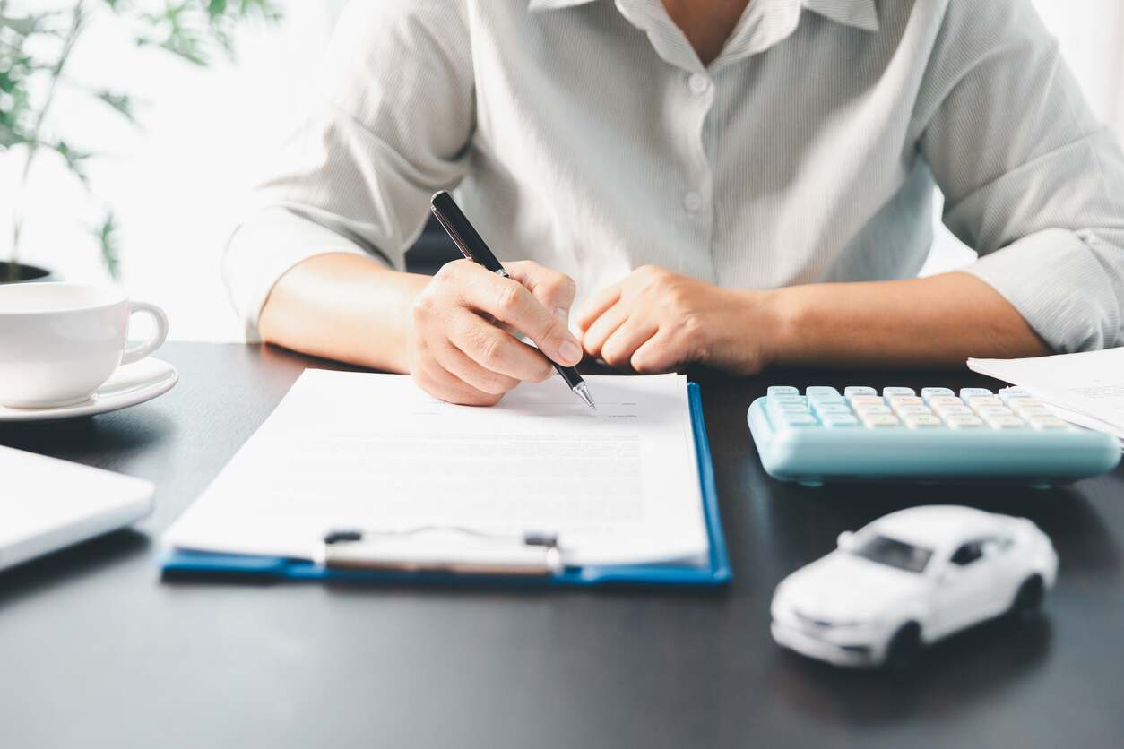 A person calculating their auto loan payment